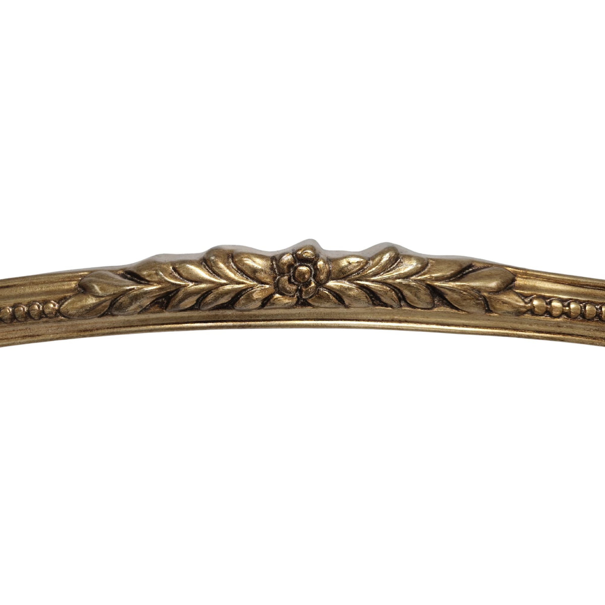 Decorative gold metal strip with leaf and floral patterns on a white background
