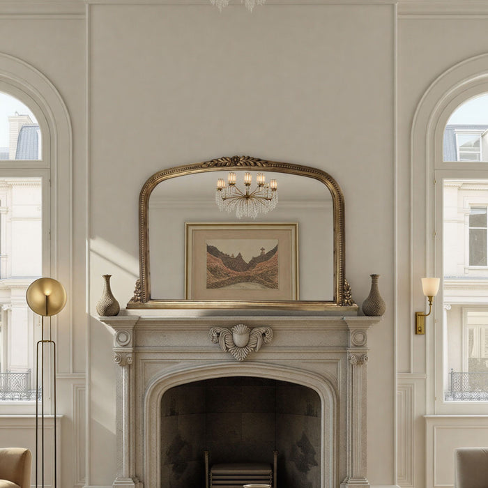Decorative mirror above a fireplace in a stylish room with arched windows.