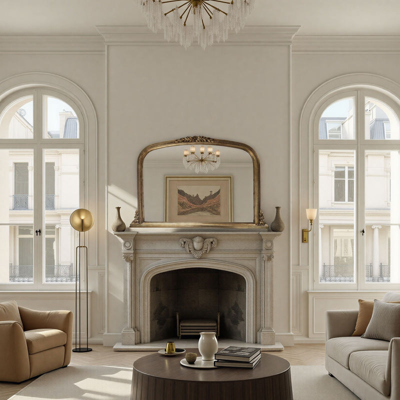Decorative mirror above a fireplace in a stylish room with arched windows.