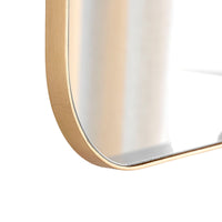 Gold-framed mirror on a white background