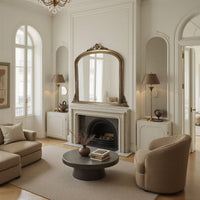 Luxurious living room with an antique gold  fireplace mirror, and elegant decor.