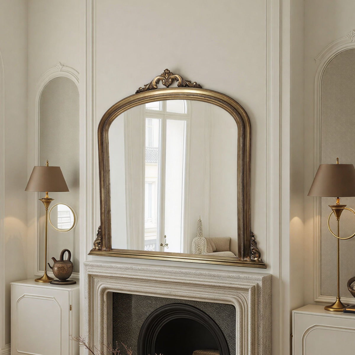 Decorative mirror with gold frame above a fireplace in an elegant room.