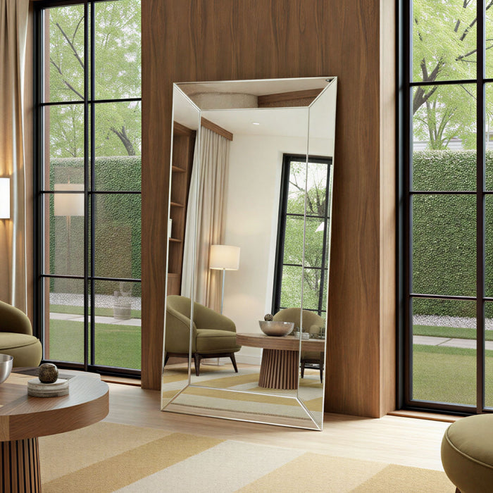 Large floor mirror in a modern living room with large windows.
