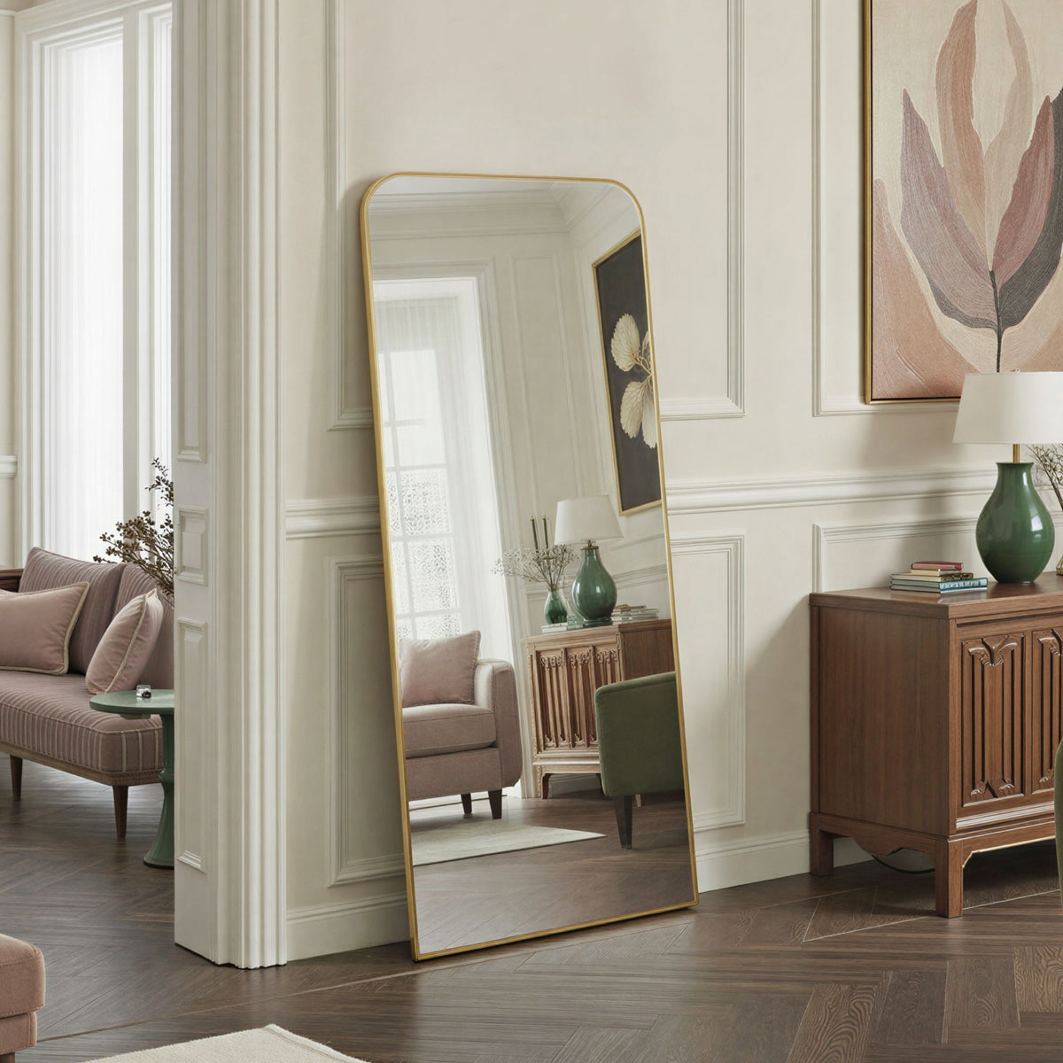 Full-length mirror with gold frame in a living room setting