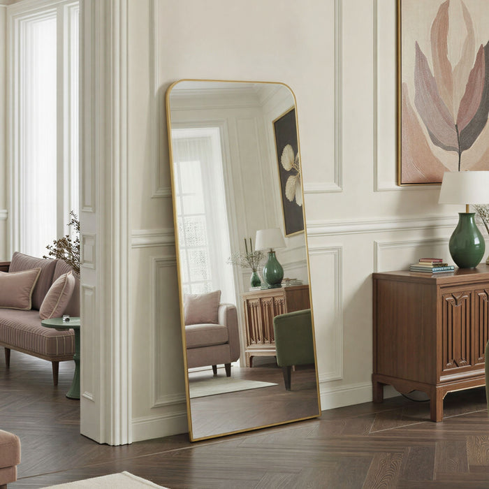 Full-length mirror with gold frame in a living room setting
